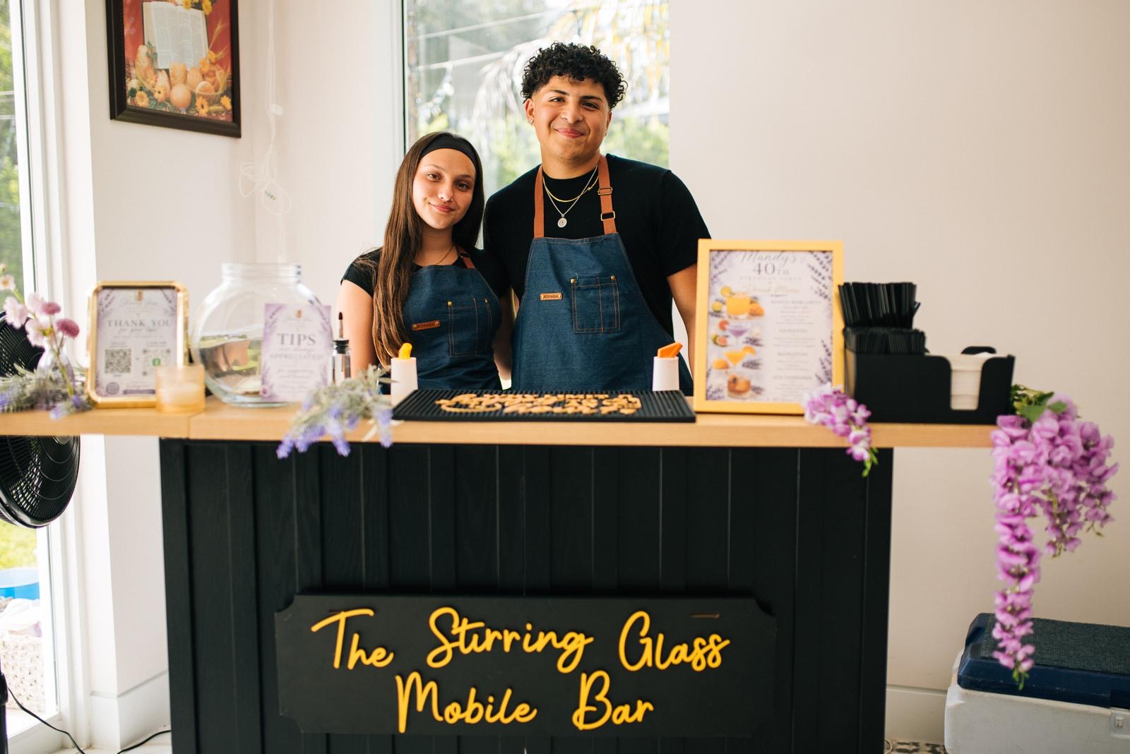 The Stirring Glass bartenders behind the mobile bar